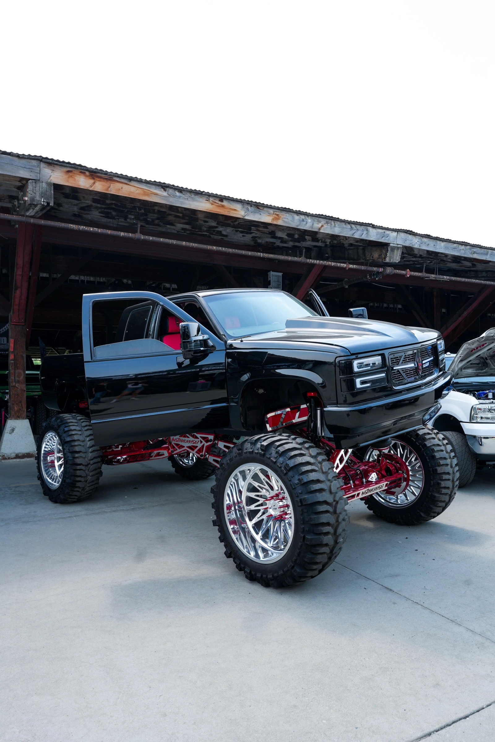Glossy black lifted pickup truck photographed for brand and social content
